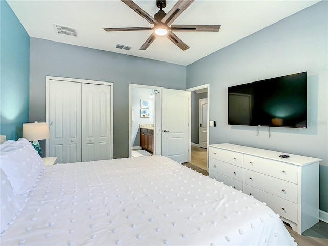 bedroom featuring ceiling fan, a closet, and ensuite bath