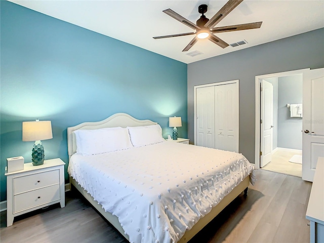 bedroom featuring hardwood / wood-style floors, ceiling fan, and a closet