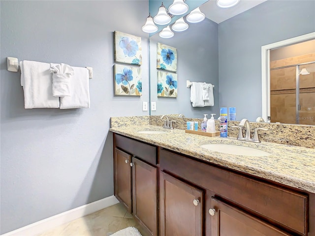 bathroom with tile patterned floors, walk in shower, and vanity