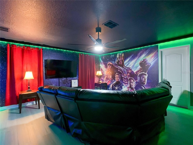 home theater room featuring a textured ceiling and ceiling fan