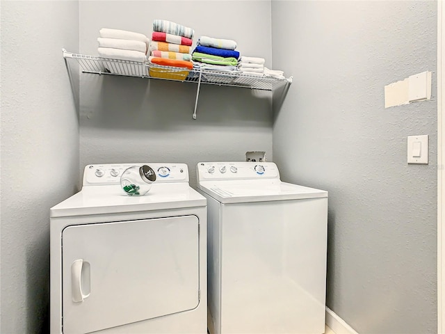 clothes washing area featuring washer and clothes dryer