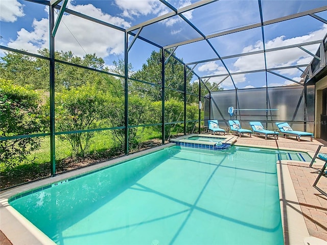 view of swimming pool featuring glass enclosure