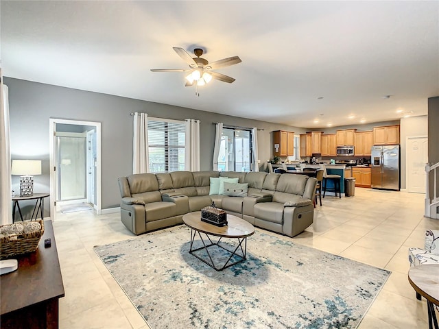 tiled living room with ceiling fan