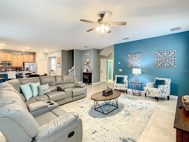 tiled living room with ceiling fan