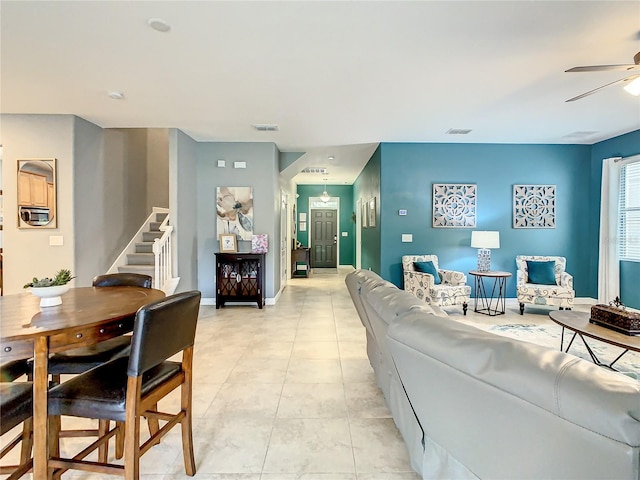 tiled living room with ceiling fan