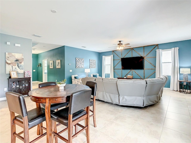 dining area with plenty of natural light and ceiling fan