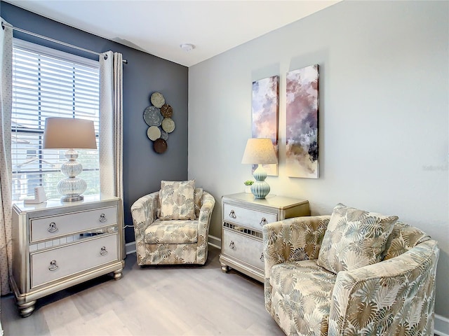 sitting room featuring plenty of natural light and light hardwood / wood-style flooring