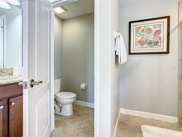 bathroom with tile patterned flooring, toilet, and vanity