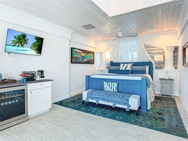 bedroom featuring beverage cooler, light wood-type flooring, crown molding, and wooden ceiling