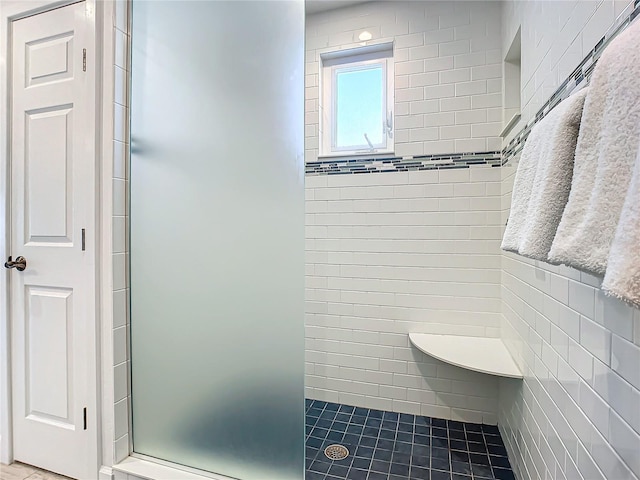 bathroom with a tile shower