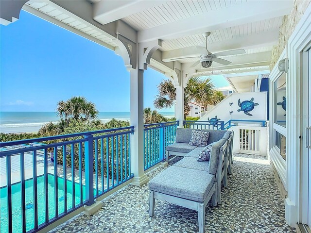 balcony with a water view and ceiling fan