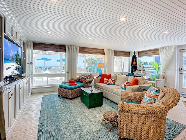 living room featuring wood ceiling, plenty of natural light, and light hardwood / wood-style floors