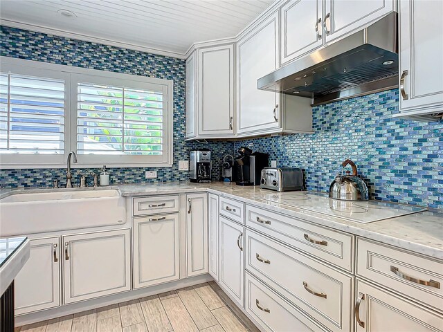 kitchen with wood ceiling, sink, decorative backsplash, white cabinetry, and electric stovetop