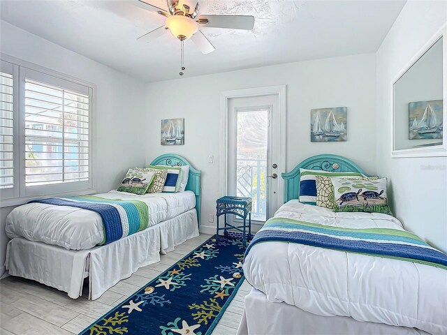 bedroom with ceiling fan, light wood-type flooring, and access to outside