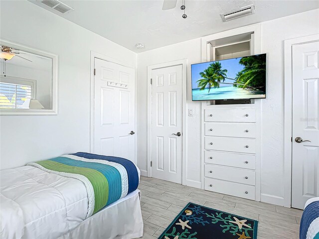 bedroom with ceiling fan and light wood-type flooring