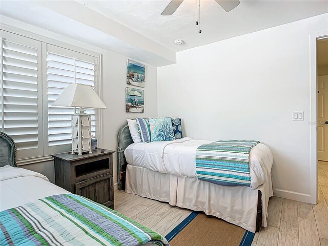 bedroom with ceiling fan and light hardwood / wood-style floors