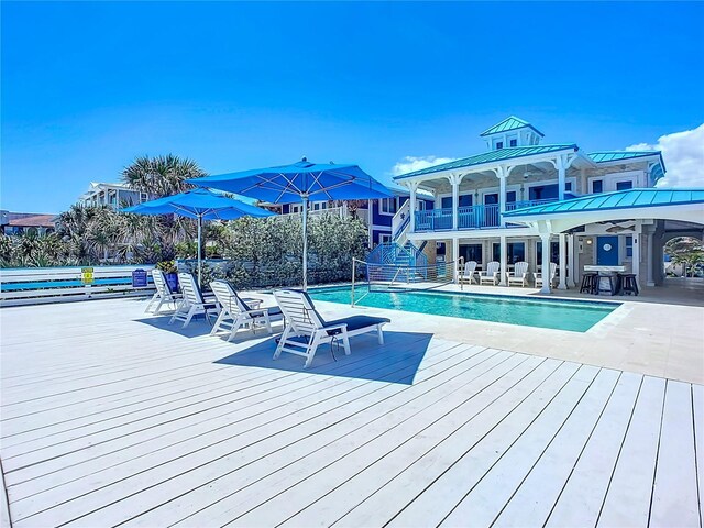 view of swimming pool featuring a patio area and a deck