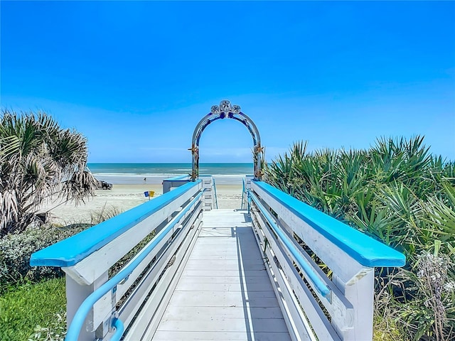 view of home's community with a water view and a view of the beach