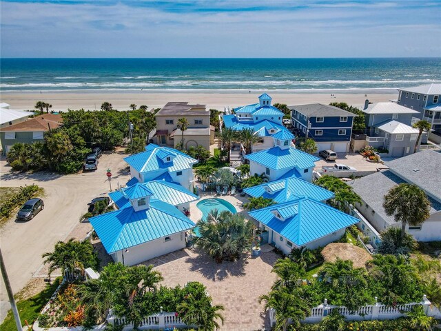 birds eye view of property with a view of the beach and a water view