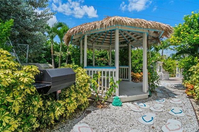 view of patio / terrace featuring grilling area, a wooden deck, and a gazebo