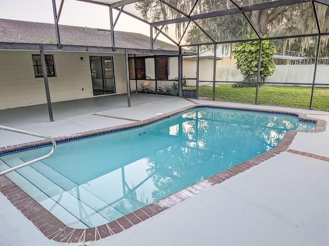 view of swimming pool with glass enclosure, a lawn, and a patio