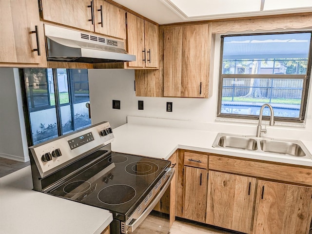 kitchen featuring electric stove, light hardwood / wood-style flooring, and sink