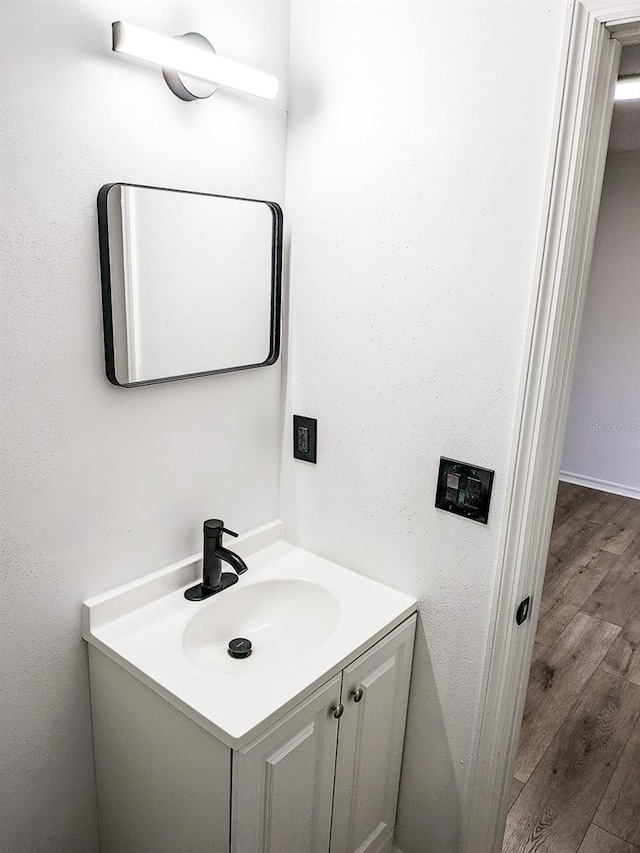 bathroom with vanity and hardwood / wood-style floors