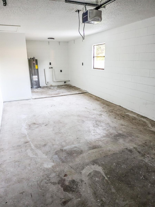 garage featuring water heater and a garage door opener