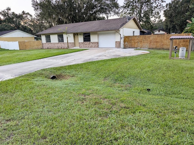 ranch-style home with a front yard and a garage