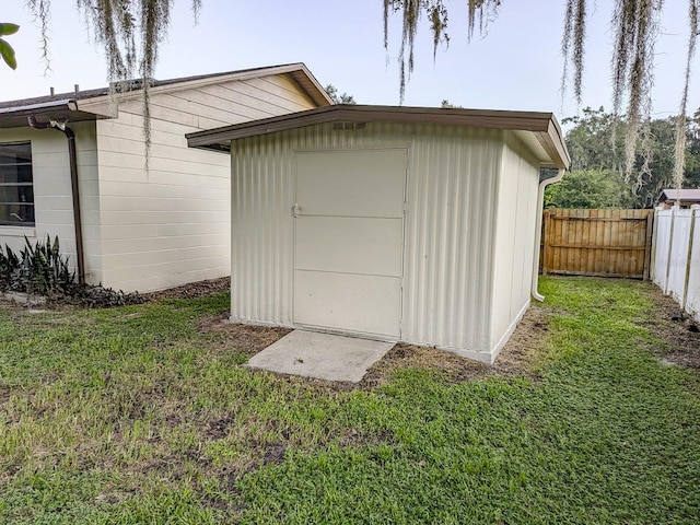 view of outbuilding with a yard