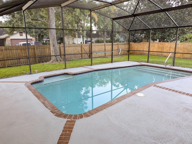 view of pool with a lanai, a patio area, and a lawn