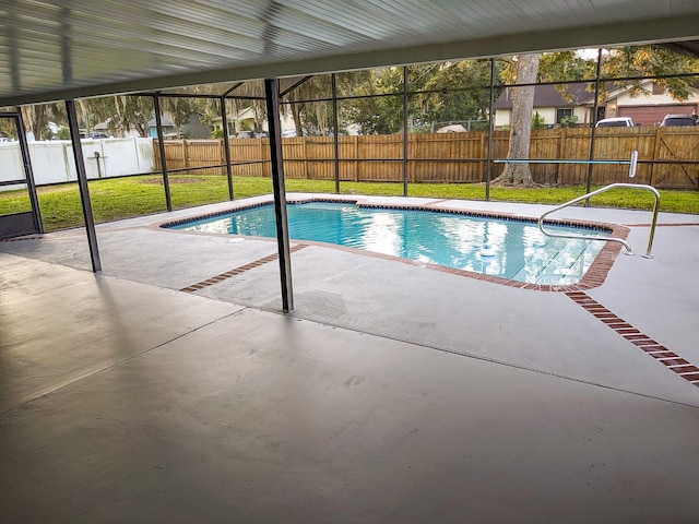 view of swimming pool with a lawn, a lanai, and a patio area