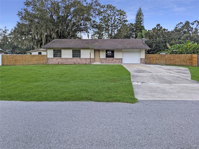 ranch-style home with a garage and a front yard