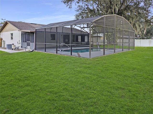 exterior space featuring cooling unit, a patio, a lanai, and a lawn