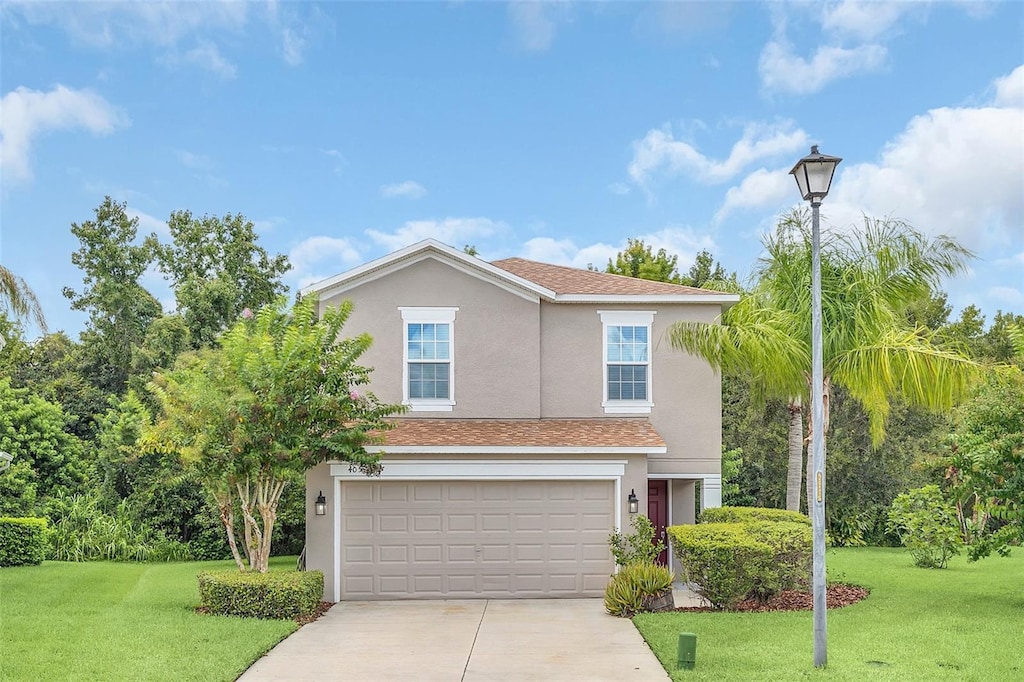 view of front of property featuring a garage and a front yard