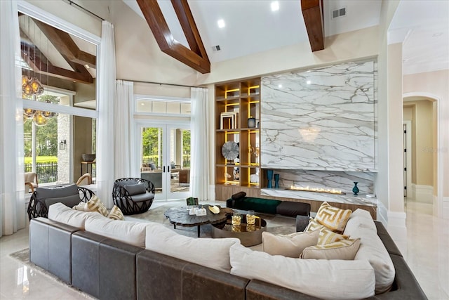 living room with vaulted ceiling with beams and a fireplace