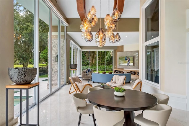 sunroom featuring plenty of natural light and a chandelier