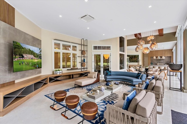 living room featuring french doors and a chandelier