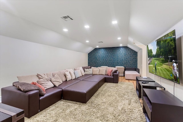 home theater with light hardwood / wood-style floors and vaulted ceiling