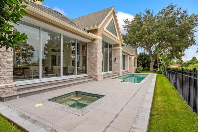 view of pool featuring an in ground hot tub and a patio area