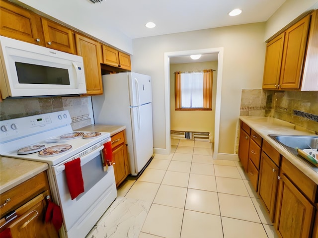 kitchen with white appliances, tasteful backsplash, and sink