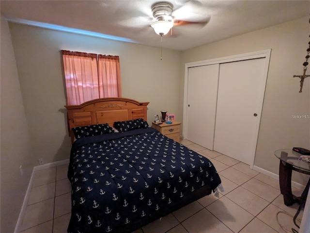 tiled bedroom featuring ceiling fan and a closet