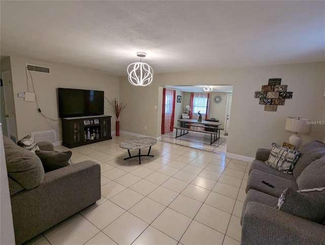 tiled living room featuring a textured ceiling