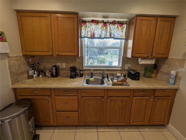 kitchen featuring sink, light tile patterned floors, and backsplash