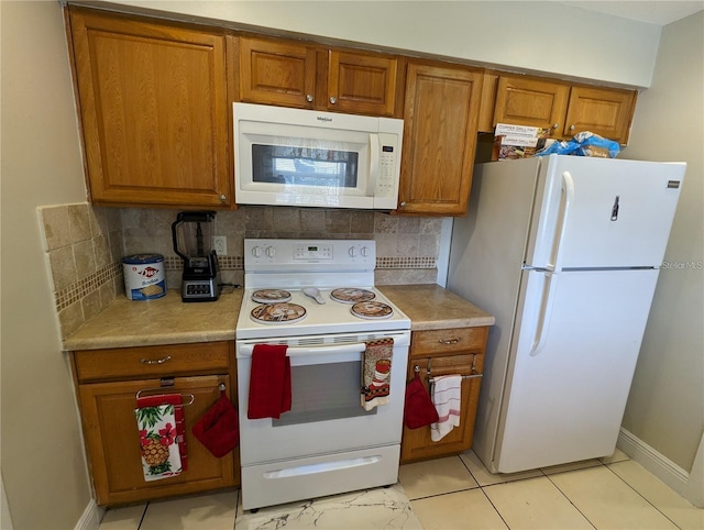 kitchen featuring backsplash, white appliances, and light tile patterned flooring