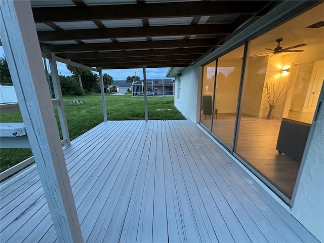 wooden deck featuring a yard and ceiling fan