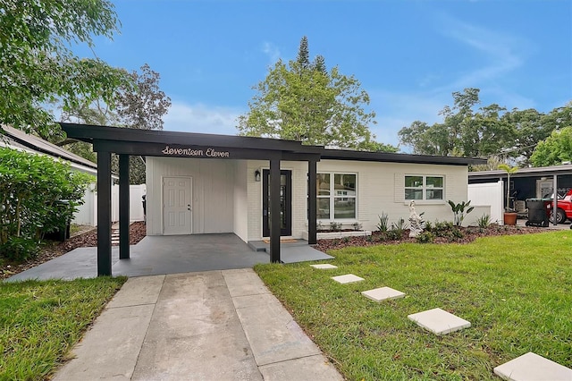 view of front of house with a front lawn and a carport