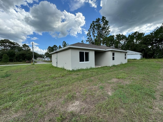 view of side of home with a lawn