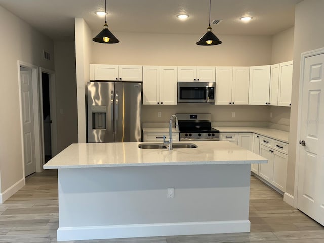 kitchen featuring light hardwood / wood-style flooring, decorative light fixtures, stainless steel appliances, and sink