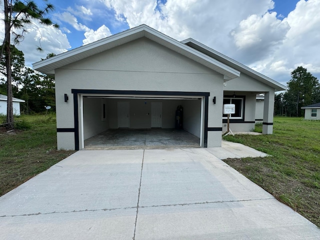 view of front of home with a front yard and a garage